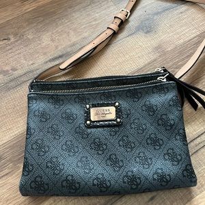 Guess. 2 zipper sections middle pocket for CC & more.Approx 8” across for size